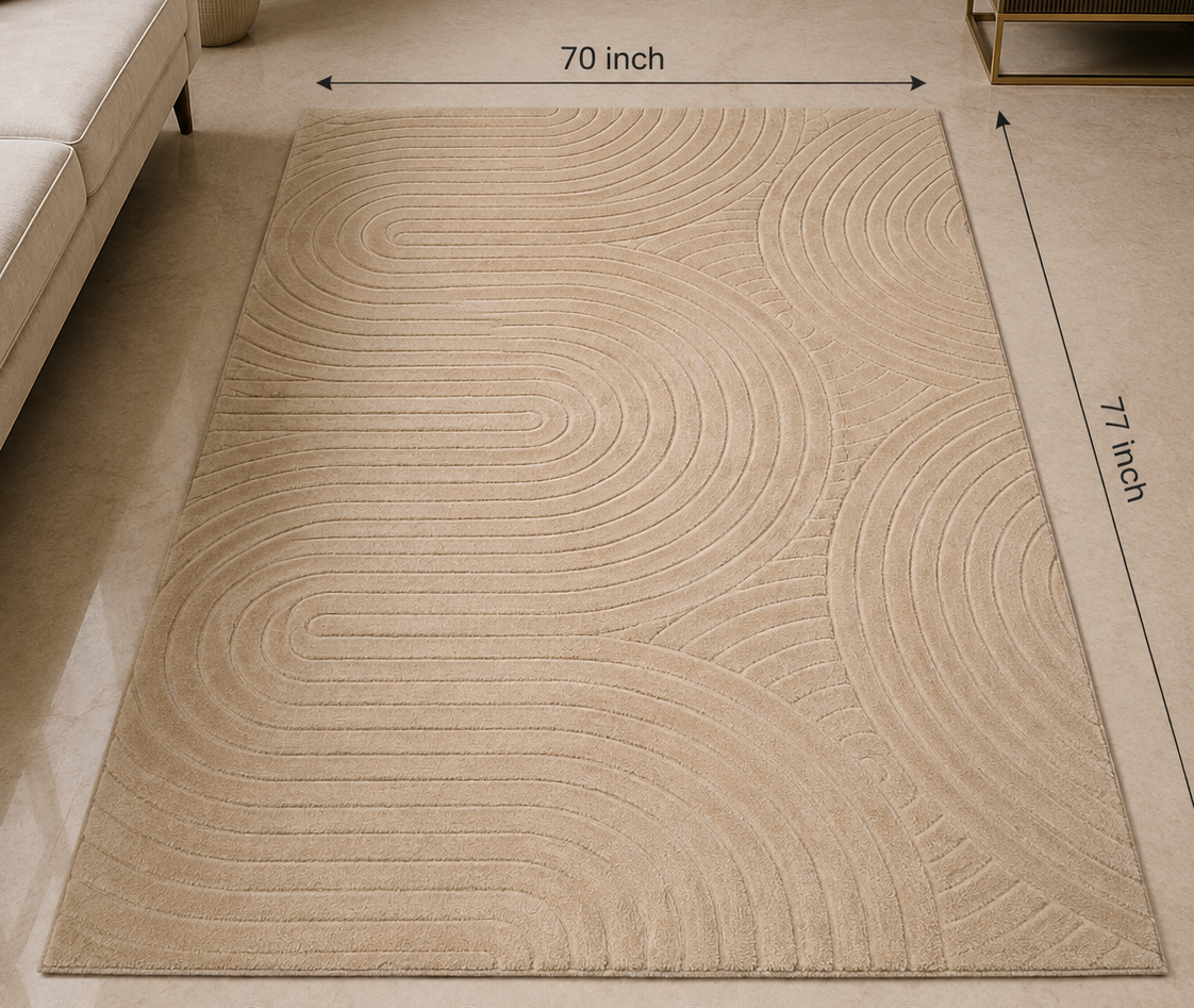 A beige rectangular area rug with a wavy concentric line pattern, shown in a styled living room setting with dimension arrows indicating 70 inch by 77 inch measurements. The image includes the DSYN brand logo at the top and feature icons at the bottom.