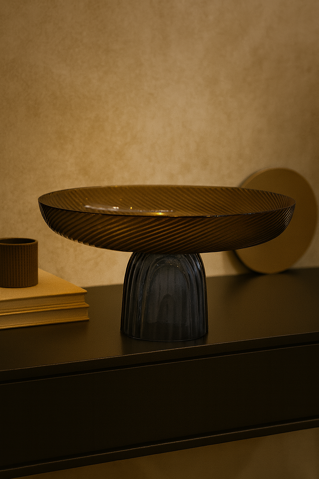 Decorative table with a textured bowl and glass vase on a wooden surface.
