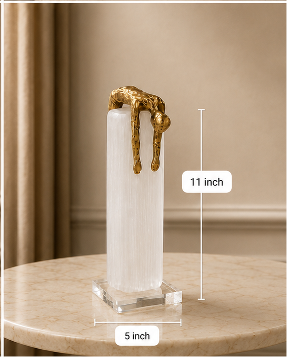 Four views of a gold sculpture on a white pedestal with measurements indicated.