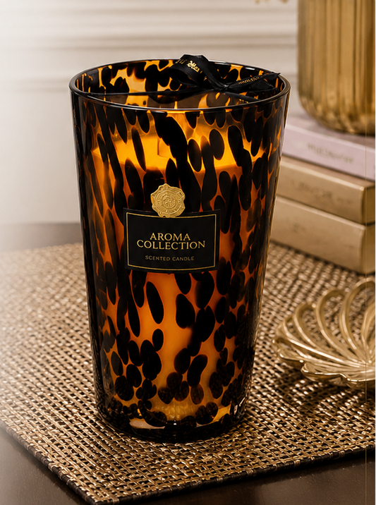 Aroma Collection luxury scented candle with tortoiseshell design on a decorative surface.