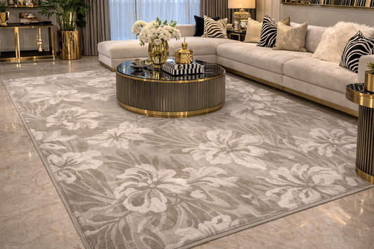 Living room with a floral-patterned rug, sectional sofa, and decorative items.