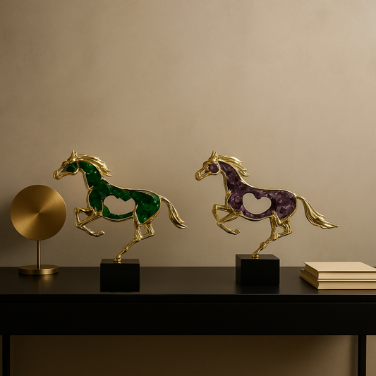 Two decorative horse sculptures on a table with a beige wall background