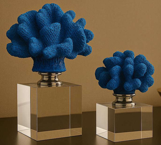 Two blue coral-like sculptures on metallic bases against a brown background