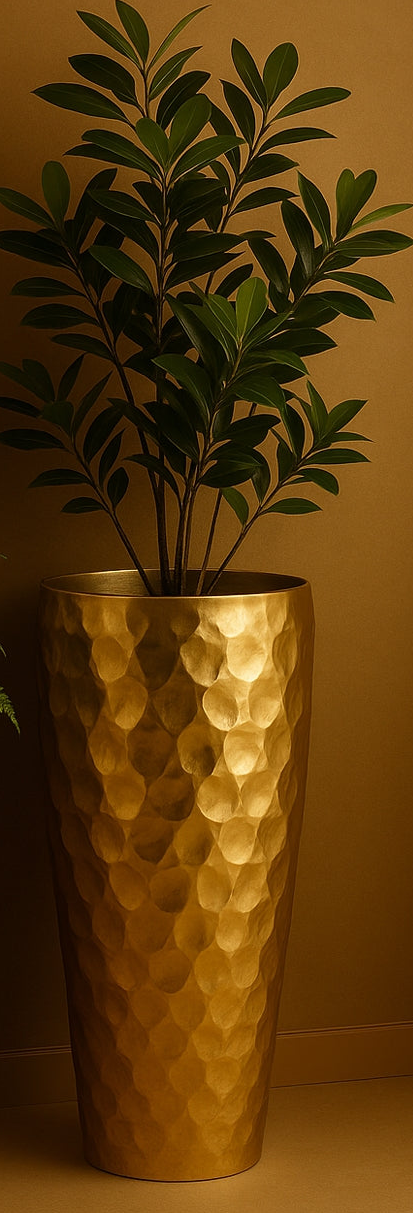 Two gold hammered planters with plants against a brown background