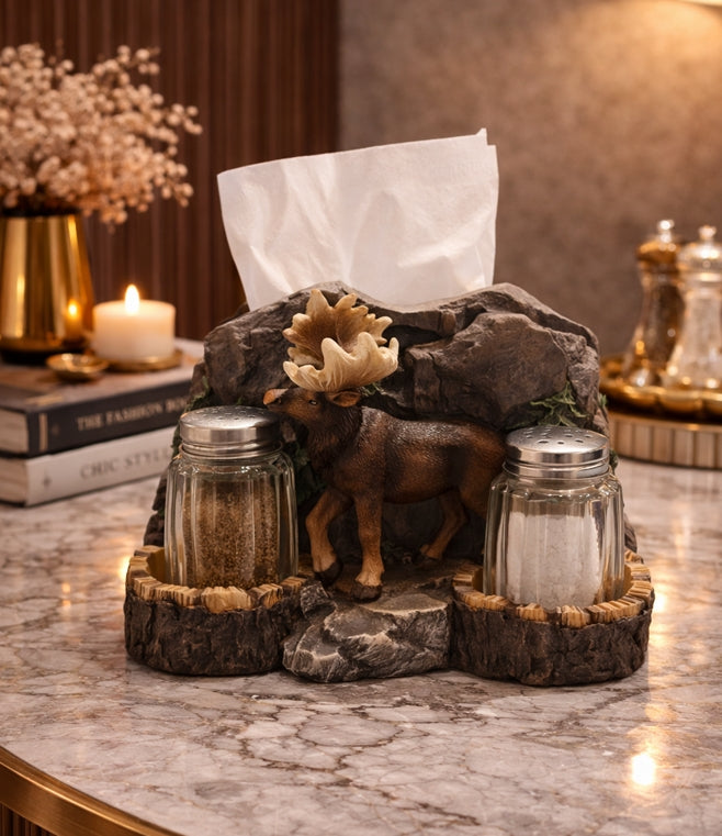 Decorative tissue holder with salt and pepper shakers and a moose figurine on a marble surface.