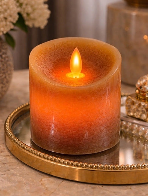 Flickering candle on a decorative tray with a blurred background