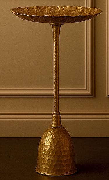 Gold decorative stand with a bowl against a brown wall