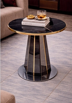 Modern side table with marble top and gold accents in a living room setting.