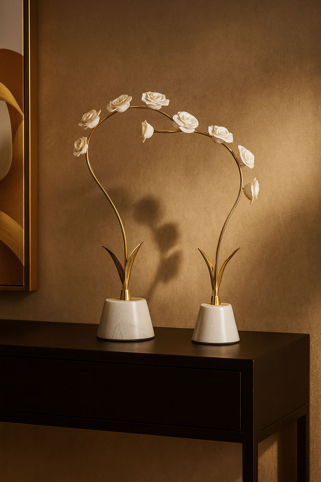 Decorative floral arrangement with gold stems and white flowers on a dark surface against a brown wall.