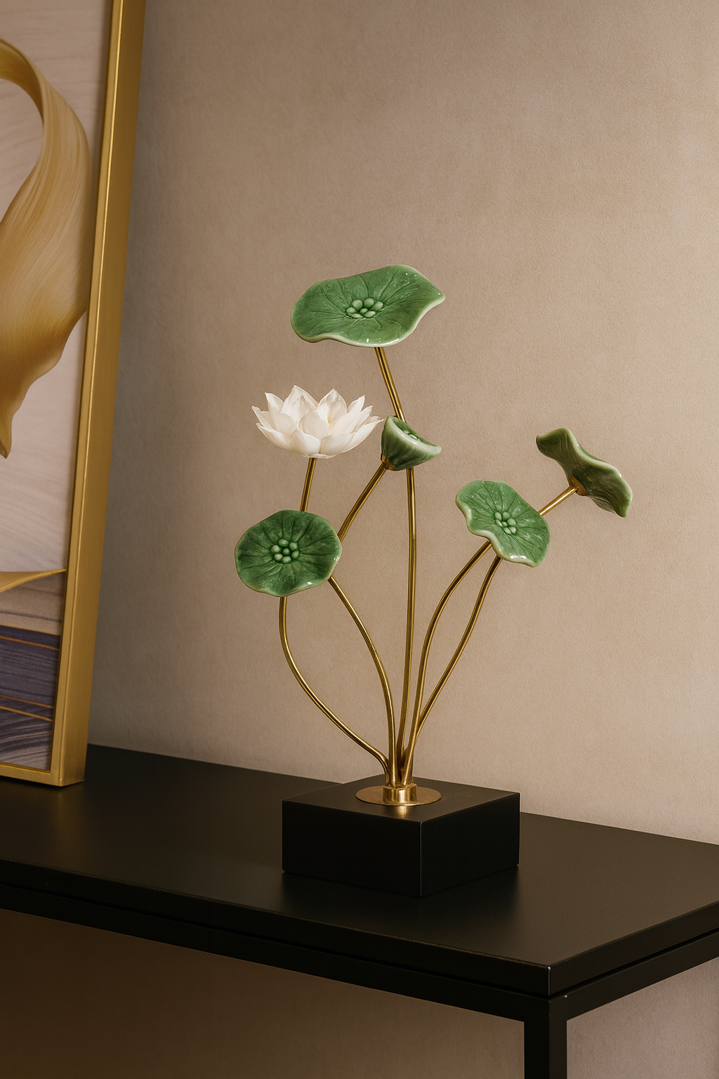 Decorative flower arrangement with white flower and green leaves on a black base against a beige wall.